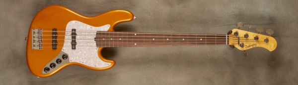 MODEL: 5-20 Vintage J-bass,
SERIAL: #7069,
FINISH: Candy apple orange,
BODY: Chambered alder,
NECK: Roasted maple with thin matte nitro finish,
FINGERBOARD: Amazon rosewood, 12″ radius, 1.875″ nut width,
PICKGUARD: Vintage pearl,
HARDWARE: Chrome,
PICKUPS: Sadowsky single-coil,
PREAMP: Sadowsky preamp with vintage tone control