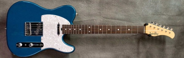MODEL: Vintage T-style,
SERIAL: #7217,
FINISH: Cerulean Pearl,
BODY: Chambered Alder,
WEIGHT: 6.70 lbs,
NECK: Maple with thin matte nitro finish,
FINGERBOARD: Brazilian Rosewood, 12″ radius, 1 11/16″ nut width with Mother of Pearl dots,
PICKGUARD: White Pearl,
HARDWARE: hardtail bridge with vintage tuners,
PICKUPS: Bare Knuckle Single Coil Pickups,
PREAMP: Sadowsky preamp with mid and mid/gain boost