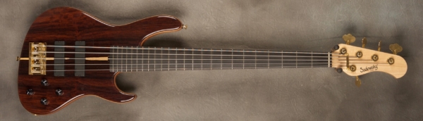 MODEL: 5-24 Standard Modern,
SERIAL: #7280,
FINISH: Natural,
BODY: Cocobolo on chambered okoume,
NECK: Maple with thin matte nitro finish,
FINGERBOARD: Ebony, 12″ radius, 1.75″ nut width,
PICKGUARD: none,
HARDWARE: Gold,
PICKUPS: Sadowsky soapbar in modern locations,
PREAMP: Sadowsky preamp with vintage tone control