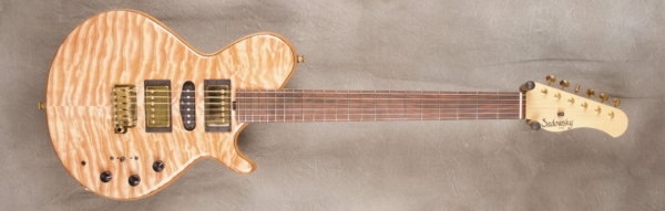MODEL: Standard LS-13 Broadway,
SERIAL: #7414,
FINISH: Natural,
BODY: Quilt maple (top and back) on chambered spruce,
WEIGHT: 7.20 lbs,
NECK: Maple with thin matte nitro finish,
FINGERBOARD: Brazilian rosewood, 12″ radius, 1.75″ nut width,
PICKGUARD: none,
HARDWARE: Gold,
PICKUPS: Sadowsky H-S-H,
PREAMP: Sadowsky preamp with mid and mid/gain boost