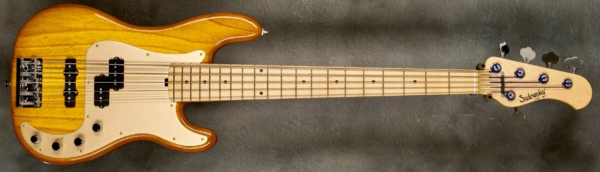 MODEL: 5-20 P5 Vintage,
SERIAL: #7587,
FINISH: Caramel Burst,
BODY: Chambered Swamp Ash,
WEIGHT: 8.32 lbs,
NECK: Maple with thin matte nitro finish and 12" radius, 1 7/8" nut width,
FINGERBOARD: Maple,
PICKGUARD: Anodized Gold,
HARDWARE: Chrome,
PICKUPS: Sadowsky P/J,
PREAMP: Sadowsky preamp with vintage tone control