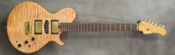 MODEL: Spruce Core LS-13 Guitar,
SERIAL: #7609,
FINISH: Natural,
BODY: Spruce core with master grade quilt maple top and back,
WEIGHT: 7.38 lbs,
NECK: Roasted Maple with thin matte nitro finish,
FINGERBOARD: Master grade Amazon Rosewood, 12″ radius, 1 3/4″ nut width,
PICKGUARD: none,
HARDWARE: Gold with Tremolo Bridge,
PICKUPS: HSH,
PREAMP: Sadowsky preamp with mid boost and gain boost, true bypass