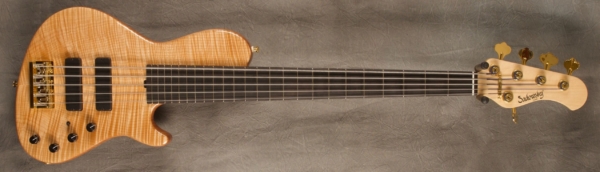 MODEL: 5-24 Single Cut 5-String Bass,
SERIAL: #7659,
FINISH: Natural,
BODY: Chambered Okume with Flame Maple top,
WEIGHT: 8.20 lbs,
NECK: Maple with thin matte nitro finish with matching headstock,
FINGERBOARD: Ebony 12" radius, 1 7/8” nut width,
PICKGUARD: None,
HARDWARE: Gold hardware,
PICKUPS: Sadowsky Soapbars, Modern location,
PREAMP: Sadowsky mid-boost preamp with vintage tone control