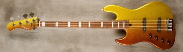 MODEL: 4-20 Standard J (lefty),
SERIAL: #8036,
FINISH: Custom Sparkle,
BODY: Chambered ash,
WEIGHT: 7.80,
NECK: Maple with thin matte nitro finish and matching headstock,
FINGERBOARD: Chechen, 12″ radius, 1.5″ nut width with white pearl block inlay,
PICKGUARD: None,
HARDWARE: chrome with D-Tuner,
PICKUPS: Sadowsky single coil in 70's locations,
PREAMP: Sadowsky preamp with vintage tone control
