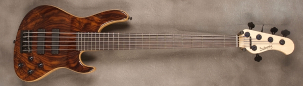 MODEL: 5-24 Modern,
SERIAL: #8115,
FINISH: Natural,
BODY: Walnut on chambered swamp ash,
WEIGHT: 8.06,
NECK: Maple with thin matte nitro finish,
FINGERBOARD: Ebony, 12″ radius, 1.875″ nut width,
PICKGUARD: None,
HARDWARE: Black,
PICKUPS: Sadowsky soapbar in modern locations,
PREAMP: Sadowsky preamp with vintage tone control