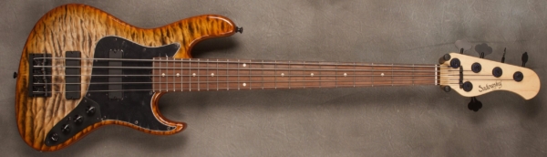 MODEL: 5-22 Will Lee,
SERIAL: #8187,
FINISH: Burnt Maple Leaf,
BODY: Chambered Alder with Quilted Maple Top w/Accent Line,
WEIGHT: 8.62 lbs,
NECK: Maple with thin matte nitro finish and 12" radius and 1 3/4 nut width,
FINGERBOARD: Madagascar Rosewood,
PICKGUARD: Black,
HARDWARE: Black,
PICKUPS: Sadowsky Soapbars in 60's Location,
PREAMP: Sadowsky preamp with vintage tone control and mid boost circuit