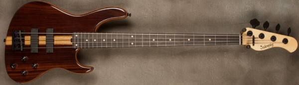 MODEL: 4-24 Modern Fretless,
SERIAL: #8331,
FINISH: Natural,
BODY: Chambered Ok0ume (African Mahogany) with East Indian Rosewood Top,
WEIGHT: 7.95 lbs,
NECK: Maple neck with thin matte nitro finish,
FINGERBOARD: Fretless Ebony 12" radius, 1.5” nut width and fret markers,
PICKGUARD: None,
HARDWARE: Black,
PICKUPS: Sadowsky Soapbars in modern locations,
PREAMP: Sadowsky preamp with vintage tone control