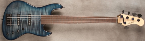 MODEL: 5-21 Standard J-bass,
SERIAL: #8416,
FINISH: Peacock Burst,
BODY: Chambered Alder with a Flame Maple Top,
WEIGHT: 8.21 lbs,
NECK: Maple with thin matte nitro finish,
FINGERBOARD: Madagascar Rosewood, 12″ radius, 1 7/8″ nut width,
PICKGUARD: None,
HARDWARE: Black,
PICKUPS: Sadowsky humcancelling in 60's Locations,
PREAMP: Sadowsky preamp with vintage tone control