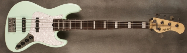 MODEL: 5-20 Vintage J-bass,
SERIAL: #8417,
FINISH: Faded Surf Green,
BODY: Chambered Alder,
WEIGHT: 8.42 lbs,
NECK: Maple with thin matte nitro finish (with white pearl block inlays),
FINGERBOARD: Brazilian Rosewood 12’ radius, 1 7/8” nut width,
PICKGUARD: White Pearl,
HARDWARE: Chrome,
PICKUPS: Sadowsky single coil JJ in 60's locations,
PREAMP: Sadowsky preamp with vintage tone control: V/V/T/T-B layout