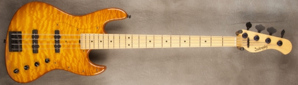 MODEL: 4-21 Standard J-bass,
SERIAL: #8581,
FINISH: Caramel Burst,
BODY: Chambered Ash with Quilted Maple top and accent line,
WEIGHT: 7.47 lbs,
NECK: Maple with thin matte nitro finish,
FINGERBOARD: Maple. 12’ radius, 1.5” nut width,
PICKGUARD: Plexi half guard,
HARDWARE: Black,
PICKUPS: Sadowsky Humcancelling, 60’s Location,
PREAMP: Sadowsky preamp with vintage tone control