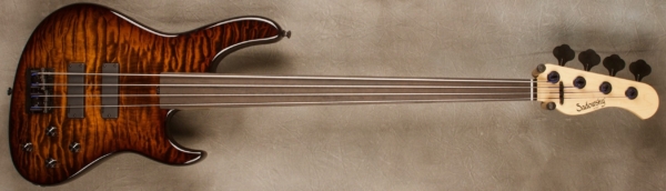 MODEL: 4-24 Modern Unlined Fretless,
SERIAL: #8620,
FINISH: Tiger Eye Burst,
BODY: Chambered Roasted Alder with Quilt Maple Top,
WEIGHT: 7.94 lbs,
NECK: Maple neck with thin matte nitro finish,
FINGERBOARD: Master Grade Fretless Ebony 12" radius, 1.5” nut width unlined,
PICKGUARD: None,
HARDWARE: Black,
PICKUPS: Sadowsky Soapbars in modern locations,
PREAMP: Sadowsky preamp with vintage tone control