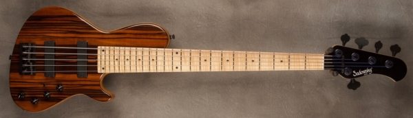MODEL: 5-24 Single Cut 5-String Bass,
SERIAL: #8677,
FINISH: Natural,
BODY: Chambered Swamp Ash with master grade Macassar Ebony top,
WEIGHT: 8.06 lbs,
NECK: Maple with thin matte nitro finish with black pearl headstock,
FINGERBOARD: Flame Maple 12" radius, 1 3/4” nut width,
PICKGUARD: None,
HARDWARE: Black,
PICKUPS: Sadowsky Soapbars in 70's Locations,
PREAMP: Sadowsky mid-boost preamp with vintage tone control