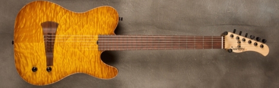 MODEL: Standard Electric Nylon,
SERIAL: #8691,
FINISH: Caramel Burst,
BODY: Chambered Alder with Quilt Maple Top,
WEIGHT: 5.83 lbs,
NECK: Maple with thin matte nitro finish,
FINGERBOARD: Madagascar Rosewood, 12″ radius, 1 7/8″ nut width,
PICKGUARD: none,
HARDWARE: Black,
PICKUPS: Barbera under-saddle,
PREAMP: Sadowsky buffer preamp