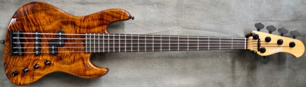 MODEL: 5-21 Vintage,
SERIAL: #8770,
FINISH: Natural,
BODY: Chambered Roasted Ash with a Koa Top,
WEIGHT: 8.5 lbs,
NECK: Roasted Maple with thin matte nitro finish and 12" radius and 1 3/4" nut width,
FINGERBOARD: Ebony,
PICKGUARD: None,
HARDWARE: Black,
PICKUPS: Sadowsky P/J,
PREAMP: Sadowsky preamp with vintage tone control