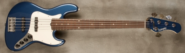 MODEL: 5-20 Ultra Vintage J-bass,
SERIAL: #8816,
FINISH: Dark Lake Placid Blue,
BODY: Chambered Alder (full-sized ultra vintage body),
WEIGHT: 8.53 lbs,
NECK: Maple with thin matte nitro finish and matching headstock,
FINGERBOARD: Amazon Rosewood 12’ radius, 1 3/4” nut width,
PICKGUARD: Parchment,
HARDWARE: Chrome,
PICKUPS: Sadowsky Single Coil JJ in 60's locations,
PREAMP: Sadowsky preamp with vintage tone control and Vol/Vol/T/T-B layout