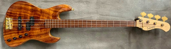 MODEL: 4-21 Verdine White,
SERIAL: #8827,
FINISH: Natural,
BODY: Chambered Alder with Koa Top,
WEIGHT: 8.20 lbs,
NECK: Maple,
FINGERBOARD: Madagascar Rosewood with a 1.5" nut width and 12" radius, no markers,
PICKGUARD: None,
HARDWARE: Gold,
PICKUPS: Sadowsky Humcancelling P/J,
PREAMP: Sadowsky preamp with vintage tone control