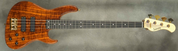 MODEL: 4-24 Modern,
SERIAL: #8966,
FINISH: Natural,
BODY: Chambered Okoume with Koa top,
WEIGHT: 7.68 lbs,
NECK: Maple with thin matte nitro finish and 12" radius, 1.5" nut width,
FINGERBOARD: Ebony,
PICKGUARD: None,
HARDWARE: Gold,
PICKUPS: Sadowsky Soapbars in Modern Locations,
PREAMP: Sadowsky preamp with vintage tone control