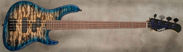 MODEL: 4-24 Standard,
SERIAL: #8992,
FINISH: T-Whale Burst with T-Blue Blue Edges,
BODY: Chambered Swamp Ash w/Master Grade Quilted Maple top,
WEIGHT: 7.93 lbs,
NECK: Maple with thin matte nitro finish and 12" radius, 1.5" nut width w/ pearl black painted headstock and D-Tuner,
FINGERBOARD: Amazon Rosewood,
PICKGUARD: None,
HARDWARE: Black,
PICKUPS: Sadowsky P/Soapbar,
PREAMP: Sadowsky mid-boost preamp with vintage tone control